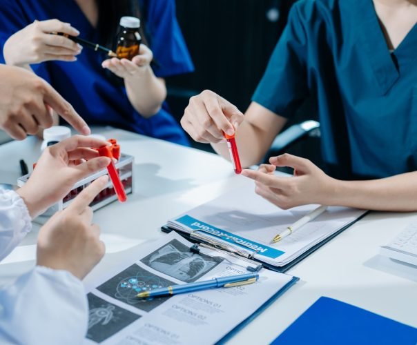 Medical technology network team meeting concept. Doctor hand working with smart phone modern digital tablet and laptop computer with graphics chart interface