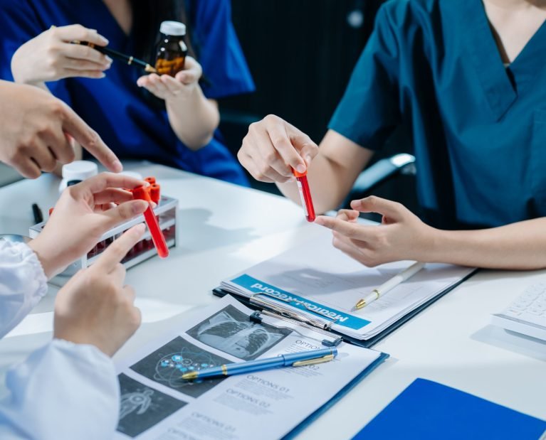 Medical technology network team meeting concept. Doctor hand working with smart phone modern digital tablet and laptop computer with graphics chart interface