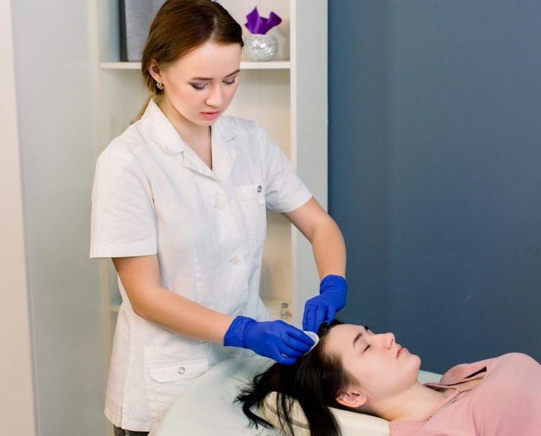 Procedure of mesotherapy. The doctor cosmetologist makes the beauty procedure in woman's head. Strengthen hair and their growth