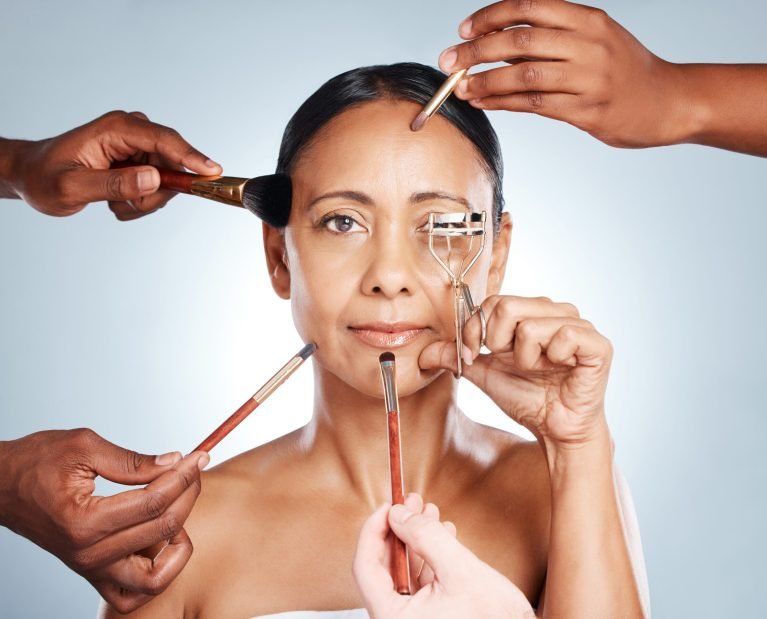 Makeup tools, hands and face with senior woman, cosmetic brush and curler for lashes for beauty iso.